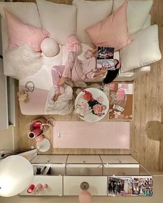 an overhead view of a living room with pink and white decor