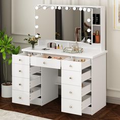 a white dressing table with drawers and lights