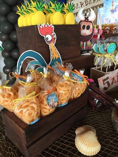 some food is sitting on a table with balloons and other decorations in the back ground