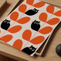 an orange and black pattern with cats on it