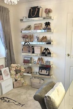 a living room filled with furniture and lots of shelves holding purses, handbags and shoes