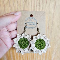 a pair of handmade crocheted flower earrings