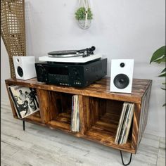 an old record player is sitting on top of a wooden entertainment center with speakers and records