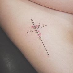 a small flower on the side of a woman's stomach