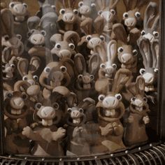 a group of stuffed animals sitting in front of a mirror