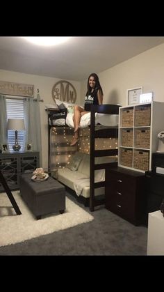 a woman sitting on top of a bunk bed in a room with carpeted floors