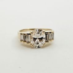 Vintage 14k Yellow Gold Cubic Zirconia Cocktail Ring, Size 8.5 Item w#189 Clean and in good condition Marked 14k 3.9 grams Oval and Baguette Cut Cubic Zirconia Size 8.5 Welcome to Westgate Jewels! At Westgate Jewels, we specialize in vintage estate jewelry, vintage designer jewelry, Vintage Native American jewelry and wears, Collectables, and Vintage fine karat gold and sterling silver jewelry. Our Collection Our shop features items in estate, antique, and vintage condition (unless otherwise not White Topaz Baguette Cut Ring With Center Stone, Oval Gold Rings With Baguette Diamonds, Baguette Cut White Topaz Ring With Center Stone, Classic Oval Topaz Ring For Anniversary, Timeless Oval Diamond Ring With Baguette Accents, Timeless Oval Diamond Ring With Baguette Diamonds, Oval Yellow Gold Ring With Baguette Diamonds, Classic Oval Topaz Ring With Prong Setting, Oval Cluster Ring With Vs Clarity For Anniversary