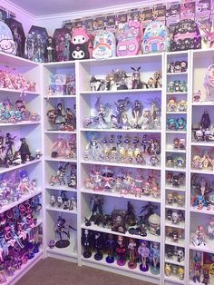 a room filled with lots of different kinds of toys and dolls on shelves next to each other