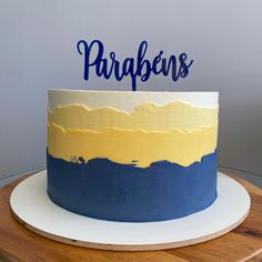 a blue and yellow cake with the word parapenns on it sitting on a table