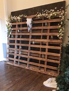 an animal skull mounted to a wooden fence with christmas decorations on it's sides