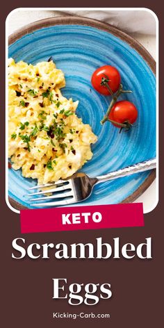 a blue plate topped with scrambled eggs next to a fork and tomato on top of it