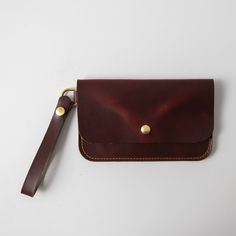 The wristlet clutch is our most versatile leather clutch, with plenty of space for your cards, keys, and phone. It's made of the same beautiful full-grain leathers as our bestselling leather tote bags and can be embossed with your initials at no additional charge. The clutch measures 8.5 inches by 5.25 inches and comes standard with a 5.5-inch wristlet strap, which is permanently affixed to a D-ring on one side of the clutch. Alternately, you can customize your clutch to wear it as a small cross Everyday Clutch Pouch With Wrist Strap, Everyday Clutch With Wrist Strap, Classic Clutch With Wrist Strap For Everyday Use, Everyday Coin Purse Clutch With Wrist Strap, Leather Wristlet Clutch With Wrist Strap, Leather Clutch Wristlet With Wrist Strap, Everyday Coin Purse With Wrist Strap, Leather Clutch Wallet With Wrist Strap, Classic Everyday Clutch With Wrist Strap