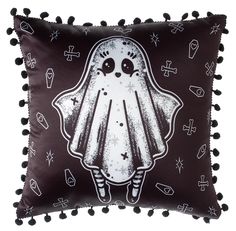 a pillow with a ghost on it and pom - poms around the edges