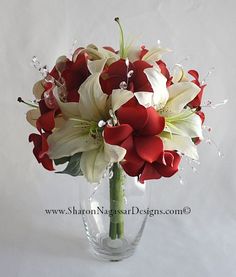 a vase filled with white and red flowers