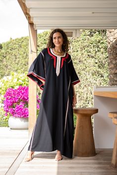 **Note : The kaftan in the video is a different color of the same kaftan and is shown to display the cut, fit, and fabric. You will receive the kaftan in the pictures.** An elegant Moroccan caftan will make you feel like African royalty. It's extremely elegant with a dash of classy cotton embroidery in the front. Ideal for plus size women as well. Made of extremely soft fabric to make you feel free and beautiful at the same time.  This Kaftan is ideal to wear for any casual occasion. Whether tak Bohemian Black Thobe Tunic, Black Bohemian Tunic Thobe, Bohemian Black Thobe In Tunic Style, Black Bohemian Style Thobe, Traditional Black Kaftan For Vacation, Traditional Black Maxi Length Thobe, Black Kaftan For Beach And Eid, Black Long Sleeve Festival Kaftan, Traditional Long Black Kaftan