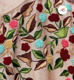 an embroidered jacket with flowers and leaves on it