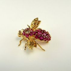 Here we have a superb sparkly diamond and ruby set bee brooch crafted in solid 14K yellow gold. This charming little bee was kept for best in a safe deposit box for several decades. He glitters beautifully in the light when you hold him. In total he weighs approximately 3.7 grams making him perfect on a lightweight blouse or a lapel of a winter coat alike. This pretty bee measures approximately 7/8" wide by 15/16" long and he is very three dimensional standing approximately 3/8" tall from the pi Yellow Gold Diamond Brooch Fine Jewelry, Diamond Yellow Gold Brooches Fine Jewelry, Yellow Gold Diamond Brooches Fine Jewelry, Yellow Gold Diamond Brooch In Fine Jewelry Style, Yellow Gold Diamond Gemstone Brooches, Gold Diamond Brooch With Gemstone, Ruby Brooch, Safe Deposit Box, Insect Brooch