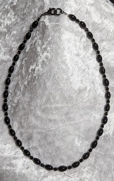 Black Crystal and Oval Onyx beads. Strung on very flexible wire. 18" long (end to end) Black Oval Beaded Necklaces, Black Necklace With Oval Spacer Beads, End To End, Onyx Bead, Beaded Necklaces, Black Crystals, Onyx, Beaded Necklace, Jewelry Necklaces