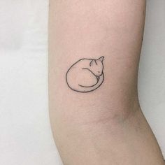 a small cat tattoo on the arm