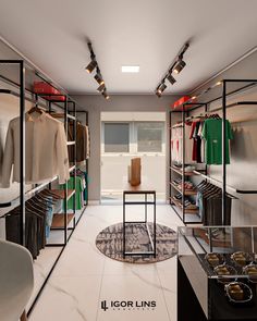 a walk in closet with lots of clothes on shelves and lights hanging from the ceiling