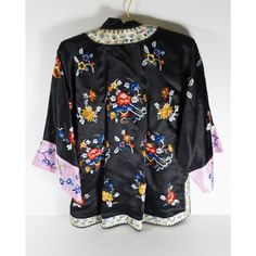 We are selling this Chinese 20th century silk embroidered jacket. The jacket has black ground color with floral motifs and pink sleeves. The jacket is small in size and probably a ladies or child size.  Condition: Good vintage condition.  Dimensions: Height 28 1/2 Inches 72.4 cm Chest Width 20 1/2 Inches 52.1 cm Width at Sleeves 48 Inches 122.0 cm Black Silk Kimono For Spring, Black Silk Outerwear For Spring, Traditional Silk Outerwear For Spring, Vintage Black Kimono For Spring, Elegant Silk Outerwear With Floral Embroidery, Spring Silk Kimono With Embroidery, Spring Silk Kimono With Floral Embroidery, Luxury Silk Outerwear With Floral Embroidery, Chinese Silk Jacket