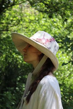 "This 'Anna' hat is one of my best sellers the shape is very flattering and offers really good protection from the sun, while creating a simple elegance in the overall look of the hat. Made from beautiful watercolour flower natural linen, with a natural linen contrast.  With two natural linen ties to secure the hat on Windy days.  The ties are 1\" wide and 23\" long The brim width is 14cm at the front tapering to 10cm at the back to offer freedom of movement, and to help stop the hat catching at Spring Bucket Hat With Uv Protection In Natural Color, Lightweight Wide Brim Sun Hat, One Size Fits Most, Lightweight Summer Fedora Sun Hat, Lightweight Fedora Sun Hat For Summer, Lightweight Straw Hat With Curved Brim, Spring Sun Hat With Uv Protection And Flat Brim, Lightweight Flat Brim Hat For Spring, Lightweight Spring Hat With Flat Brim, Lightweight Wide Brim Hat For Spring