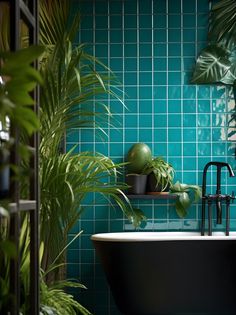 a bath tub sitting next to a lush green plant in a room with blue tiled walls