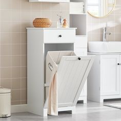 a bathroom with a sink, mirror and towel rack