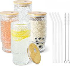 there are many glass jars with straws next to each other on the white background