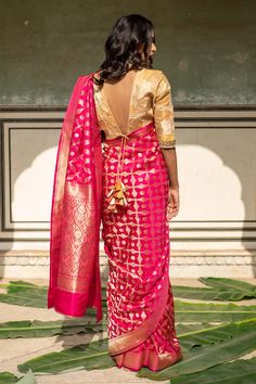 Indian pink silk banarasi saree with floral and geometric jaal woven motifs. Comes with running blouse piece.
Components: 1
Pattern: Woven
Type Of Work: Floral, geometric
Fabric: Banarasi Silk
Color: Pink
Other Details: 
Note: Stitched blouse worn by the model is not for sale
Disclaimer: The joint fabric pieces may vary. Designers unique process ensures that the placement of fabric will always be similar but not same. They always create the product with stretch fabrics of similar types and weigh Silk Banarasi Saree, Indian Pink, Banarasi Silk Saree, Geometric Fabric, Floral Geometric, Handmade Textiles, Banarasi Saree, Blouse For Women, Banarasi Sarees