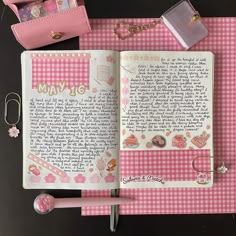 an open notebook with writing on it next to a pink purse and keychain