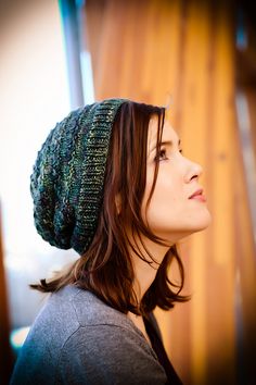 a woman wearing a knitted hat looking up