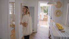 a woman standing in the doorway of a house