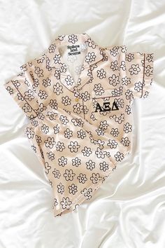 Our Greek Letter Beige Daisy Pajamas are made of an ultra soft satin fabric with a hint of spandex. Featuring an airy and breathable fit with your sorority letters printed on the front pocket. All of our pattern pajamas are designed and personalized with love in our small business studio. We are proud to be female & family owned and officially greek licensed. · Satin blend fabric· Elastic waist bottoms· Shorts feature pockets Colors may slightly vary due to different screen settings Kappa Delta Chi, Phi Sigma Rho, Silk Pjs, Alpha Epsilon Phi, Sigma Delta Tau, Theta Phi Alpha, Delta Phi Epsilon, Wishlist 2024, Alpha Omicron Pi