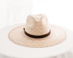 Hats are sized at 58cm (large) and include an adjustable inner, cotton sweatband for a more comfortable fit. Each hat comes with a genuine brown leather hatband.

Each handmade hat is unique and may have small imperfections or vary in size and color. All Leah products are responsibly sourced and ethically crafted. Adjustable Brimmed Brown Straw Hat, Adjustable Brown Straw Hat With Short Brim, Adjustable Brown Panama Hat In Country Style, Adjustable Brown Country Panama Hat, Adjustable Natural Fedora For Everyday, Adjustable Brown Panama Hat For Rodeo, Adjustable Brown Sun Hat With Short Brim, Rustic Brown Fedora With Curved Brim, Rustic Brown Panama Hat With Curved Brim