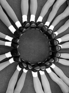 black and white photograph of people's legs arranged in a circle