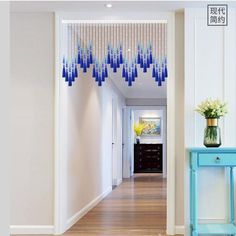 the hallway is decorated with blue and white beaded curtains hanging from it's ceiling