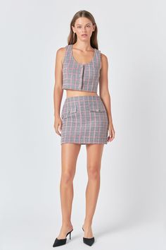 This chic mini tweed skirt is perfect for everyday wear! Crafted from grid tweed fabric with a fitted silhouette it features a unique front pocket with button detail for added style. The perfect combination of fashion and function the mini length makes it versatile and easy to style. Enjoy the sophisticated look of this skirt - head turning style and comfort you'll love! Grid tweed Fitted Mini length Front pocket with button Hidden side zipper Lining Hand wash cold Do not bleach Do not tumble dr Tweed Crop Top, Button Crop Top, Tweed Skirt, Tweed Fabric, Sleeveless Crop Top, Gray Skirt, Skirts For Sale, Side Zipper, Turning