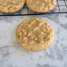 three cookies cooling on a wire rack