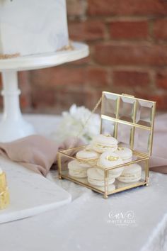 a table topped with a cake and lots of macaroons on top of it