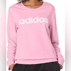 The Adidas Essentials Logo Sweatshirt Will Keep You Warm And Comfortable All Day Long. Fitted Cuffs And A Ribbed Collar Give It A Polished, Yet Casual Look. Adidas Relaxed Fit Sweatshirt With Ribbed Cuffs, Cozy Crew Sweats, Comfy Pink Top With Ribbed Cuffs, Comfortable Pink Top With Ribbed Cuffs, Adidas Sporty Tops For Loungewear, Sporty Adidas Tops For Loungewear, Pink Logo Print Sweatshirt, Adidas Relaxed Fit Sweatshirt For Spring, Adidas Winter Tops Relaxed Fit