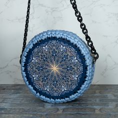 a blue and white plate sitting on top of a wooden table next to a black chain