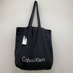 Black Calvin Klein Tote Bag, Light Weight Trendy Calvin Klein Rectangular Bag, Chic Black Canvas Bag With Adjustable Strap, Modern Calvin Klein Black Bag, Modern Black Calvin Klein Bag, Chic Black Canvas Bag With Dust Bag, Calvin Klein Black Rectangular Bag, Black Rectangular Calvin Klein Bag, Chic Black Canvas Bag With Removable Pouch, Calvin Klein Black Shoulder Bag With Removable Pouch