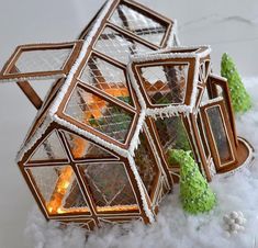 an ornament made out of wood and glass in the snow