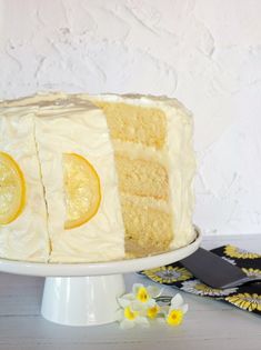 a cake with white frosting and lemon slices