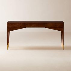 a wooden desk with two gold legs