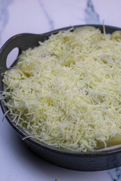 a pan filled with cheese sitting on top of a counter