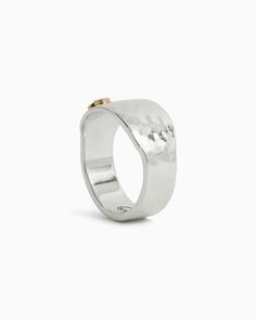 Add a contemporary touch to your everyday style with the Hammered Statement Band. This wide sterling silver band features a dainty 14K solid gold petroglyph on the front, blending two tones seamlessly. Its simplicity speaks volumes, making a subtle yet impactful statement. Metal: Sterling silver with 14K gold accent Band Width: 8mm Style #: R115G Everyday Hammered Thick Band Jewelry, Minimalist Hammered Wide Band Jewelry, Modern Wide Band Ring With Hammered Detail, Everyday Hammered Wide Band Jewelry, Everyday Wide Band Hammered Jewelry, Modern Thick Band Jewelry For Promise, Modern Wide Band Promise Ring, Modern Hammered White Gold Jewelry, Hand Forged Modern Jewelry For Anniversary