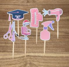 Hair Stylist Cupcake Toppers - Set of 12 Celebrate a hair stylist's graduation or milestone with these unique and adorable cupcake toppers! Features: - Set of 12 cupcake toppers attached to bamboo sticks - Printed on premium card stock for durability and quality - Designs include: hair dryer, scissors, curling iron, sit-down hair dryer hood, hair clip and spray bottle - Perfect for hair stylist graduation parties, beauty school celebrations, or hair salon events Details: - Each topper is approxi Cosmetology Graduation Party, Beauty School Graduation, Cosmetology Graduation, Hooded Hair Dryer, School Celebration, Graduation Party Supplies, Cupcake Designs, Beauty School, Graduation Decorations