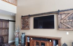 Special walnut Wall-mounted TV concealed with the wooden barn doors from the TV Hide package Barn Door Shutters, Bar Tv, Outdoor Tv Covers, Barn Door Cabinet, Track Door, Barn Door Installation, Sliding Shutters, Hidden Tv, Tv Covers